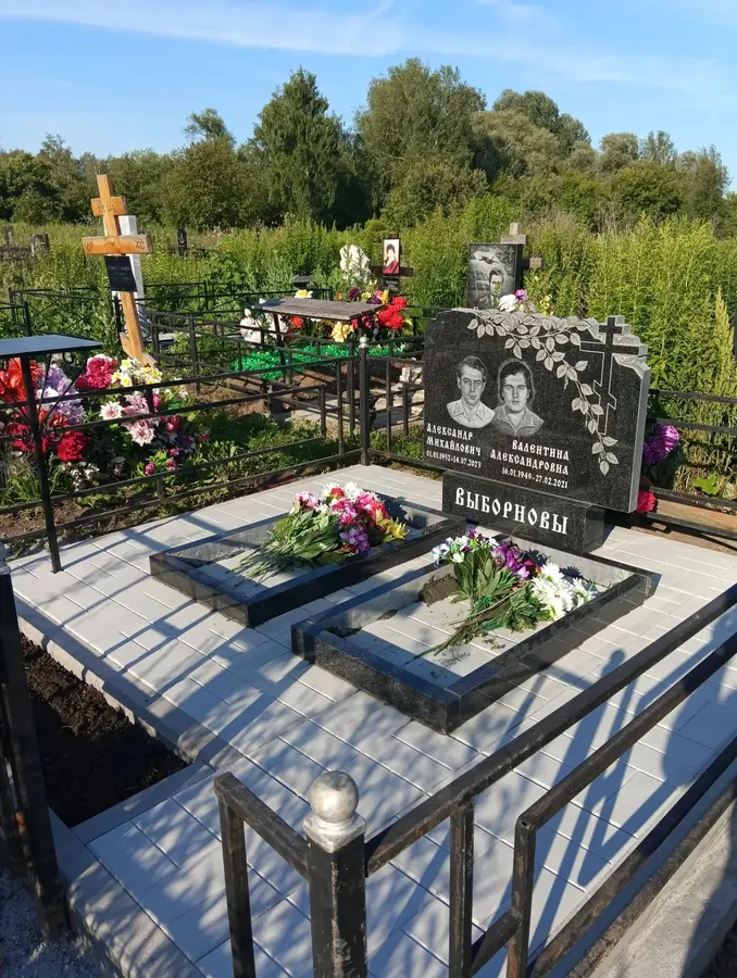 Семейный памятник из двух стел с растительной гравировкой и мощением